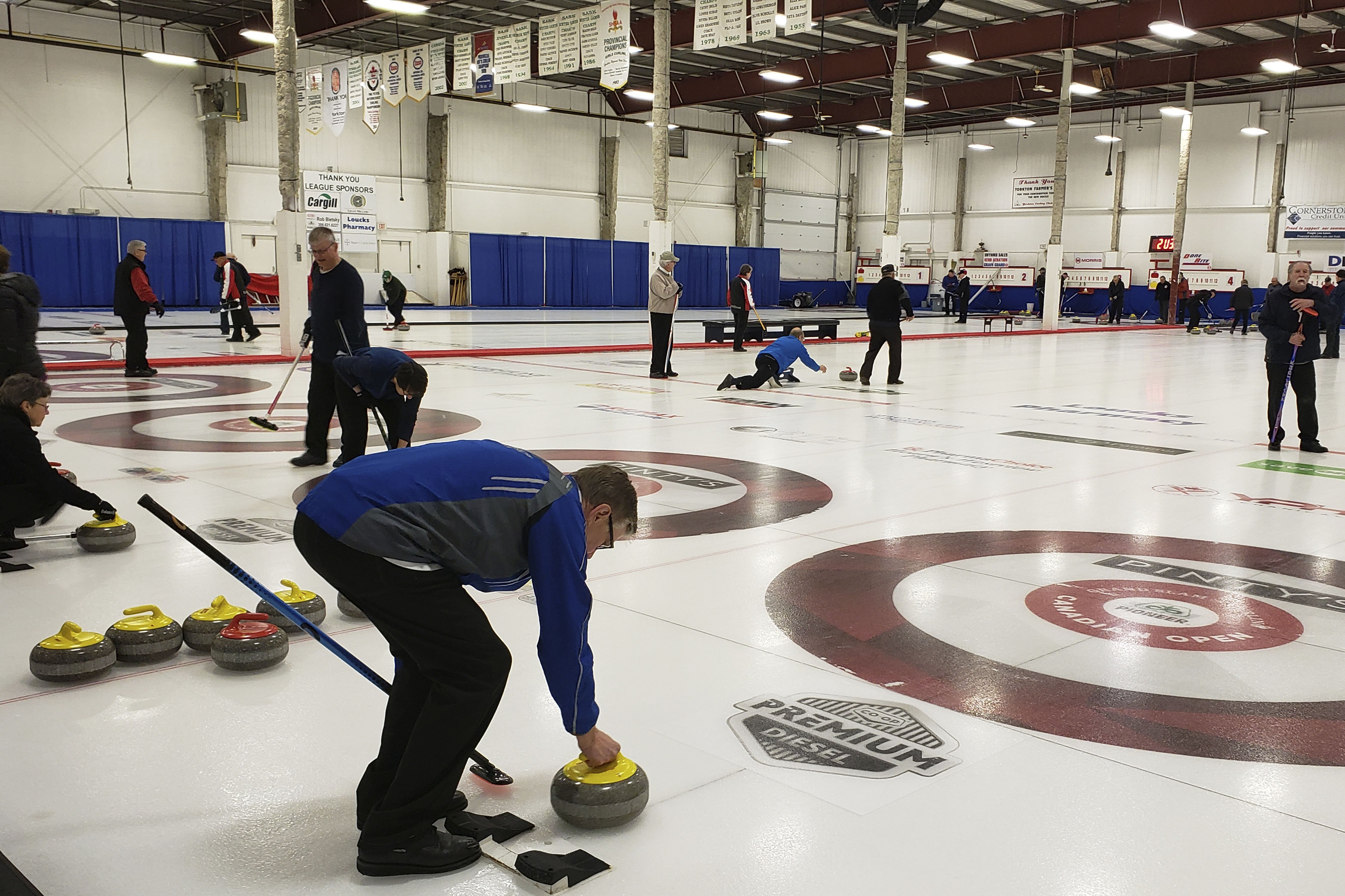 people curling on indoor ice